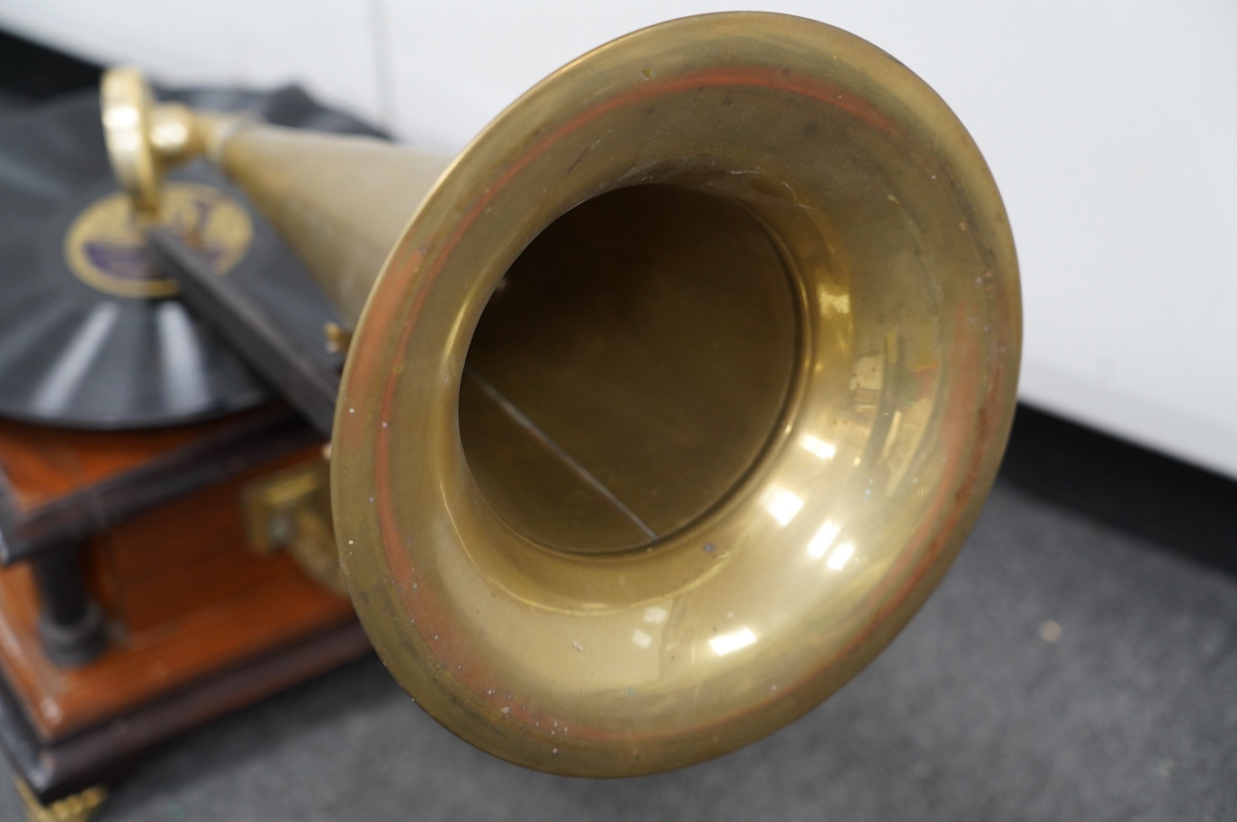 An early 20th century ‘His Masters Voice’ mahogany and ebonised gramophone with brass horn, base 29 x 29cm. Condition - fair